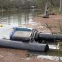 Photo of an irrigation pump floating on a creek